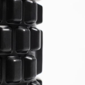Foam roller met grid-patroon voor blessure en herstel vanuit een close up - AJ-Sports